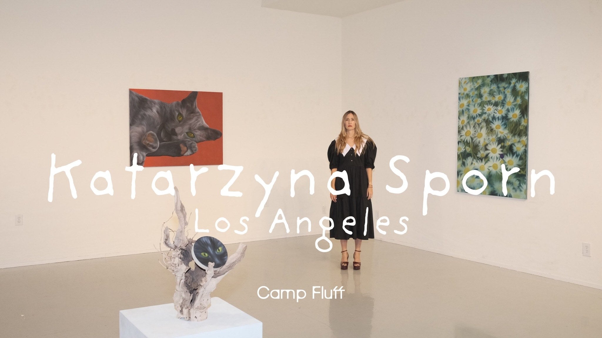 Katarzyna Sporn standing with her paintings in Los Angeles